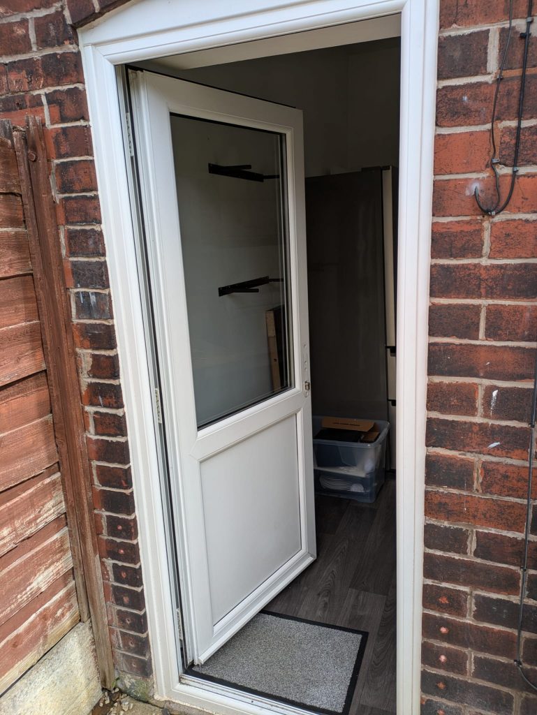 A UPVC door repair where the door is now open but the handle has been removed to allow for fixing the door mechanism